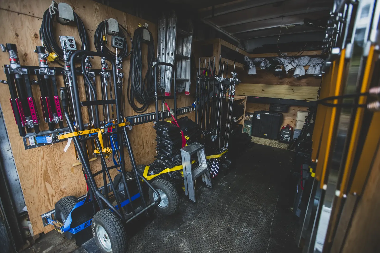 Grip and electric truck interior packed with stands, carts, cable and production equipment
