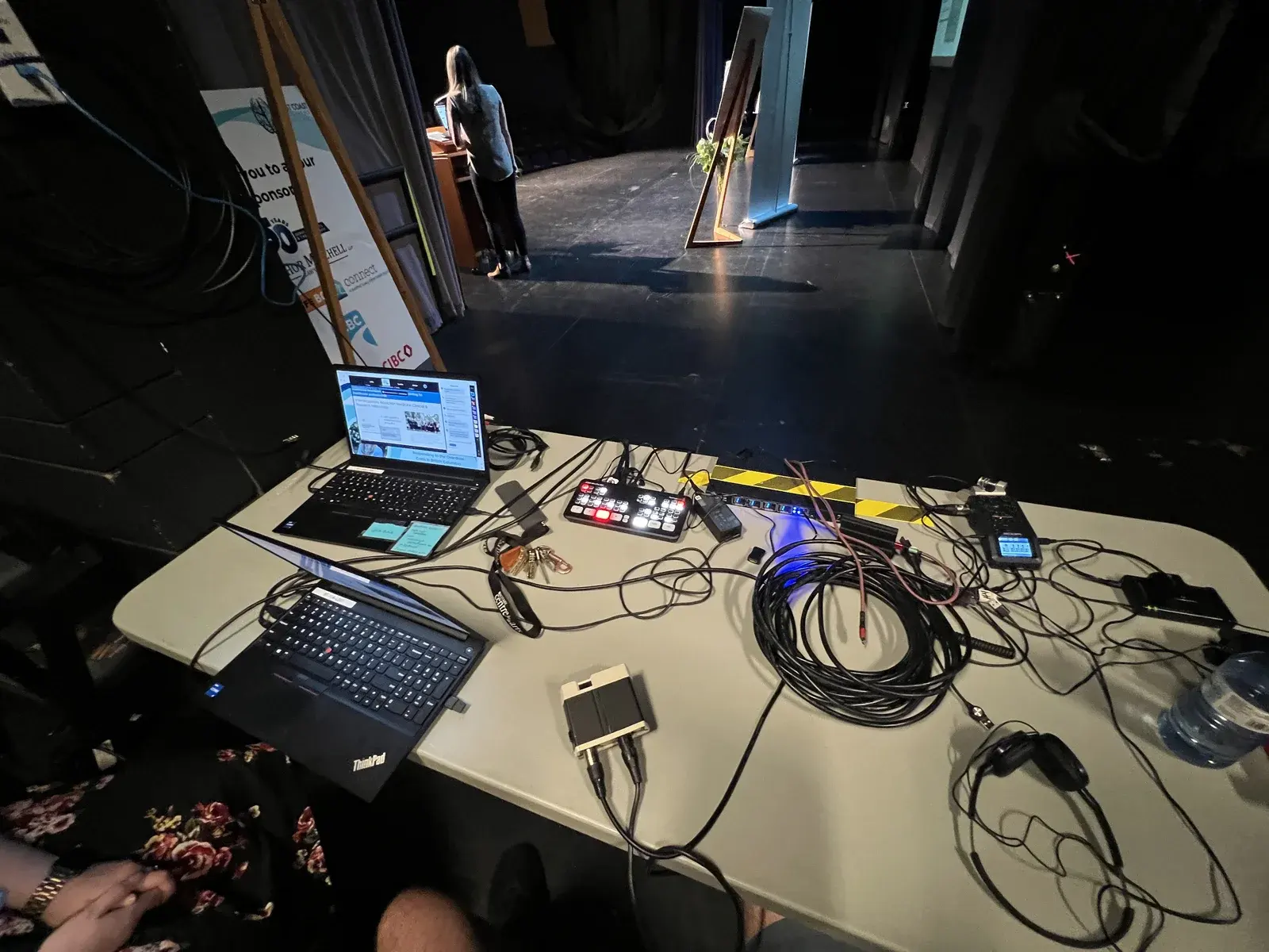 Streaming and switching table with laptops, cables and production monitors