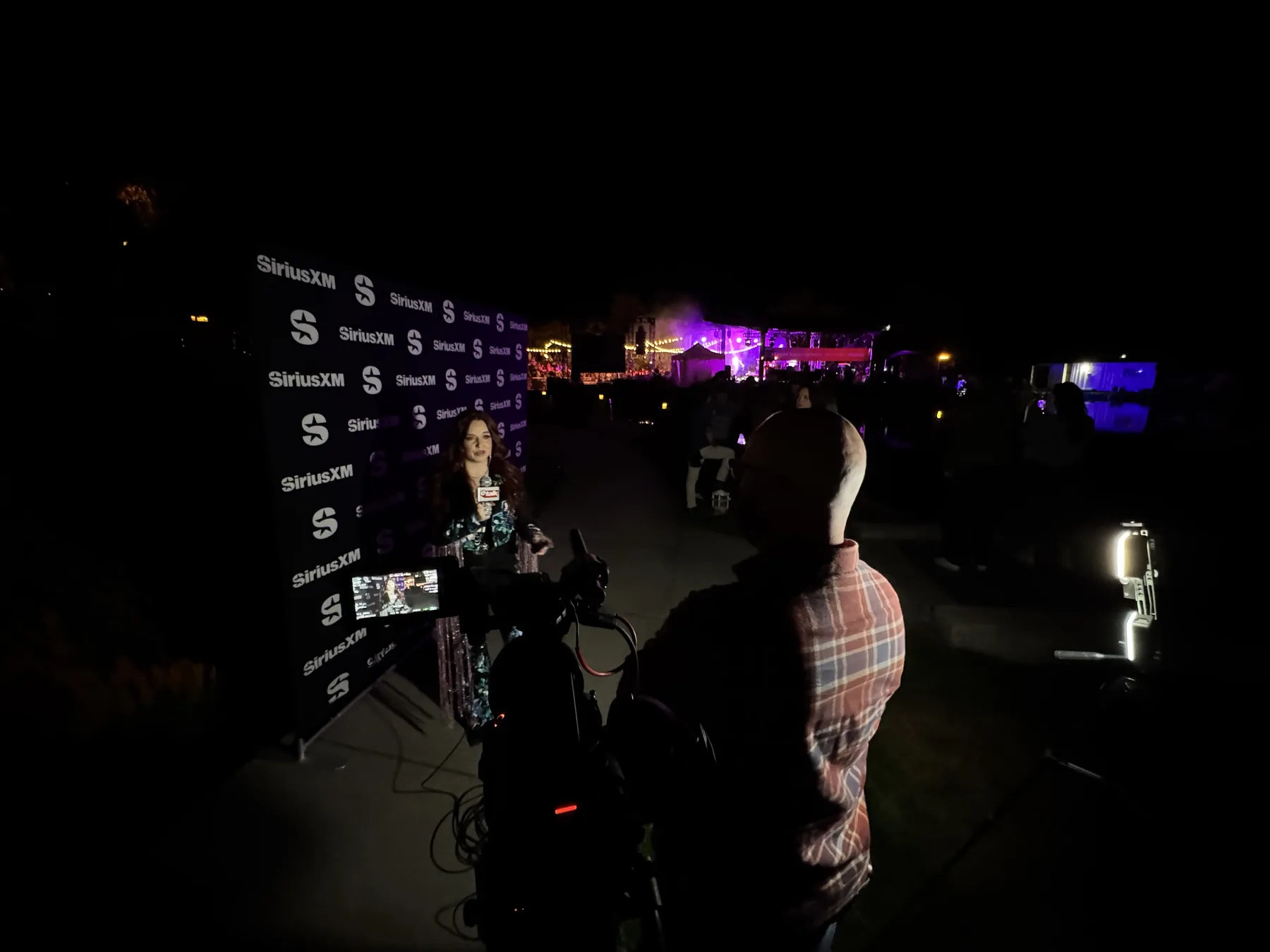 Night interview setup with eTalk microphone and SiriusXM backdrop at the Kelowna waterfront