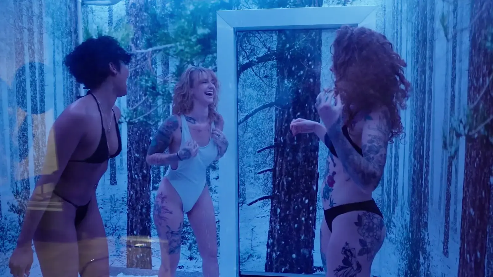 Guests laughing inside the blue-lit snow room in the finished Cleopatra's Rituals commercial