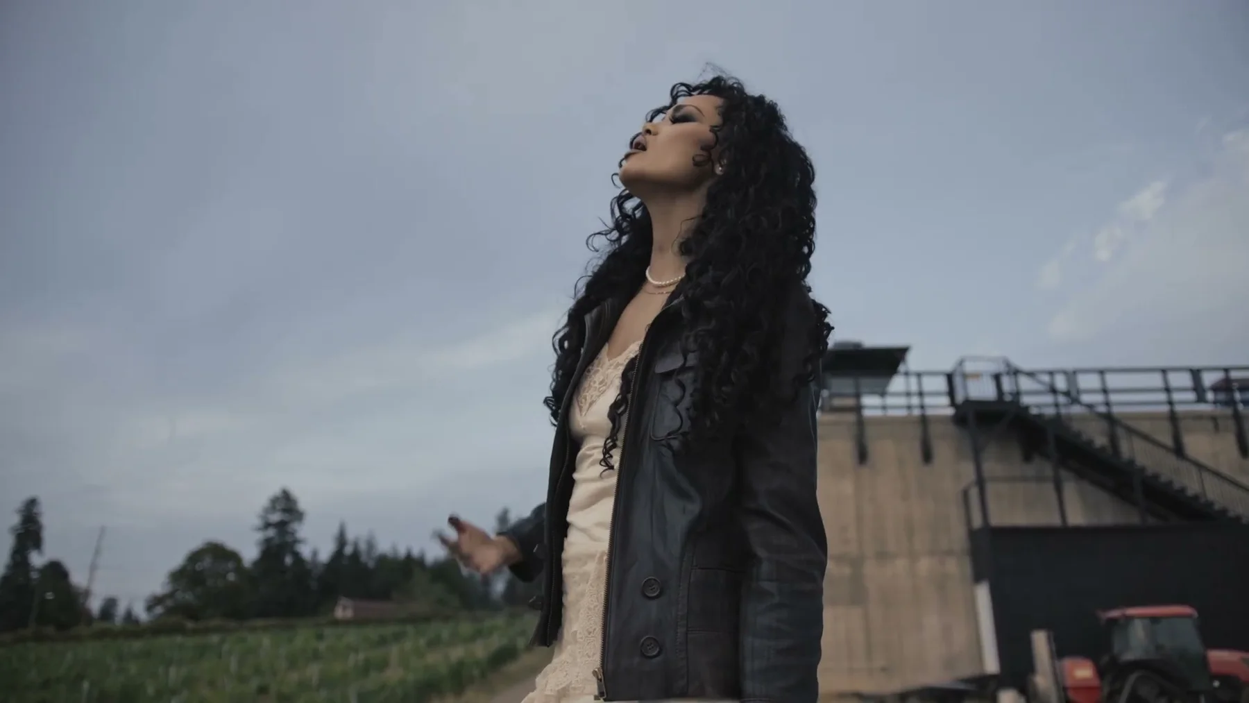 Alexandra Wright singing outdoors beneath an overcast sky in Colorado