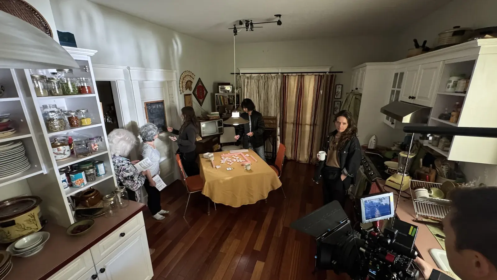 Wide behind-the-scenes view of The Knitting Diaries kitchen set with camera and performers