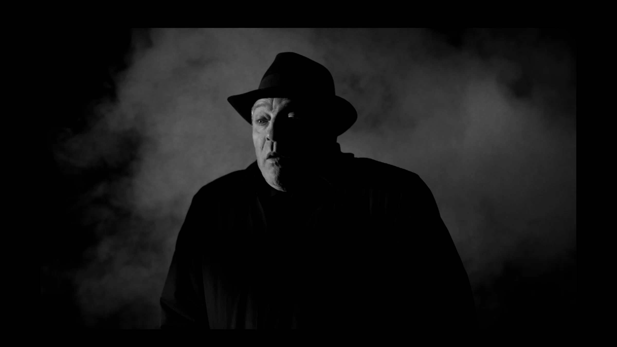 Roark Critchlow lit through smoke and hard shadow in a Last of a Dying Breed production frame