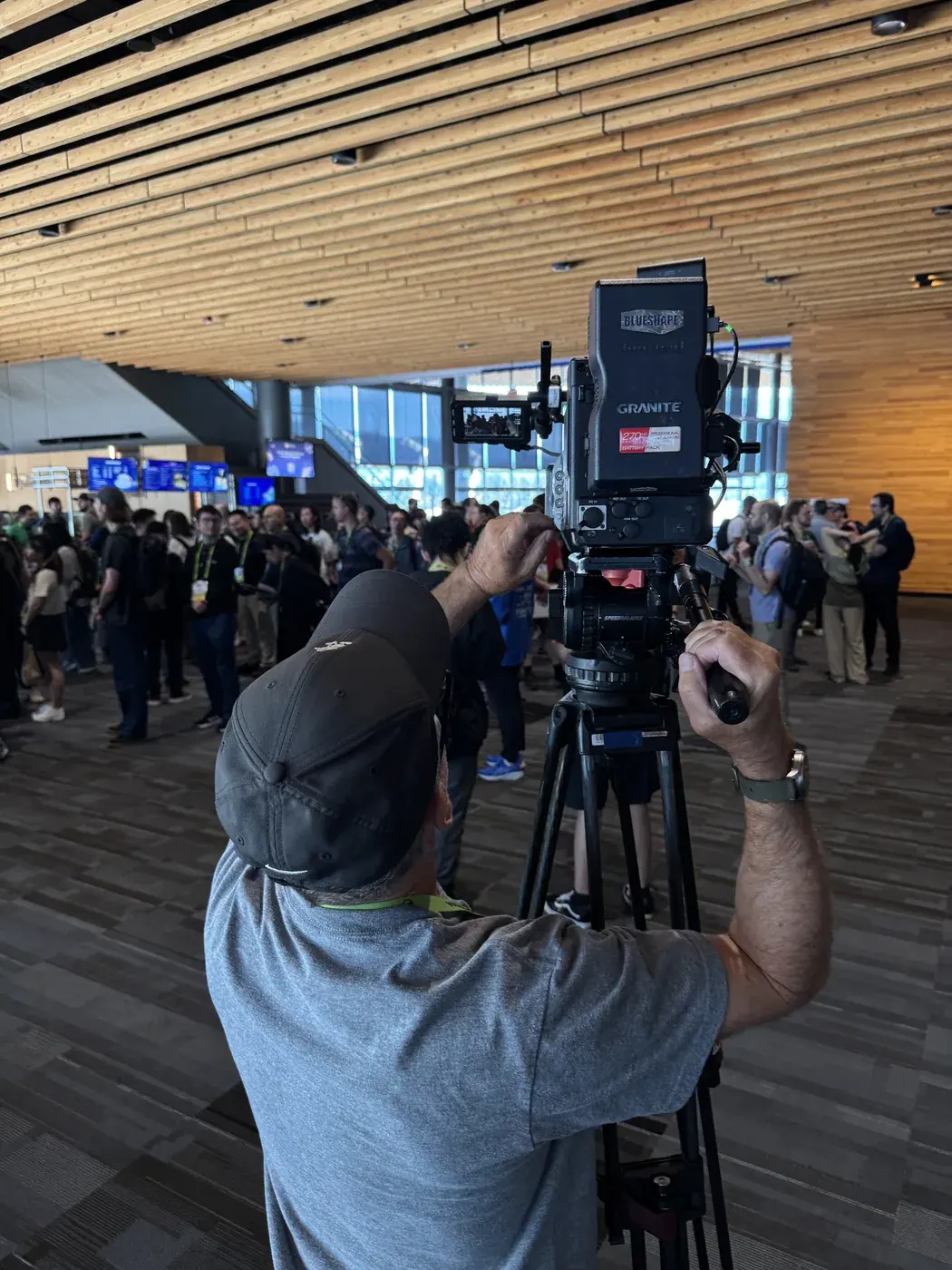 Broadcast camera positioned in a busy Vancouver Convention Centre lobby during NVIDIA SIGGRAPH support
