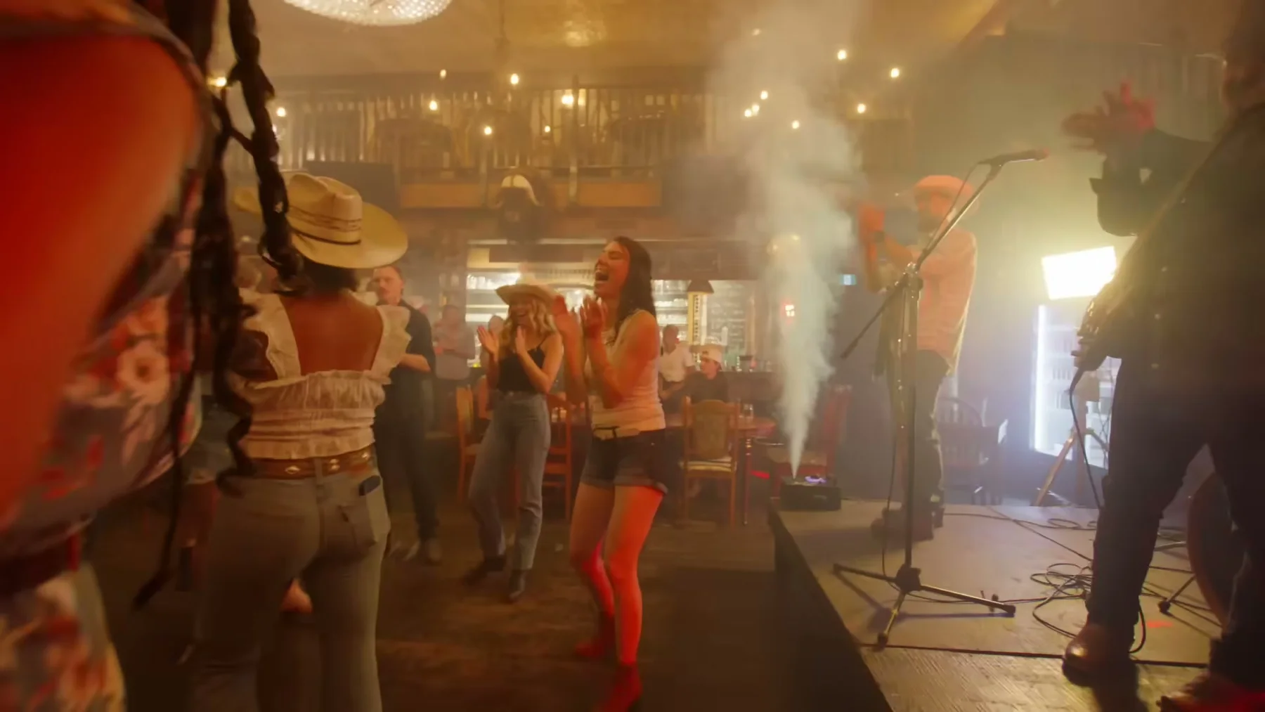 Band and dancers inside the bar performance scene in Open Road