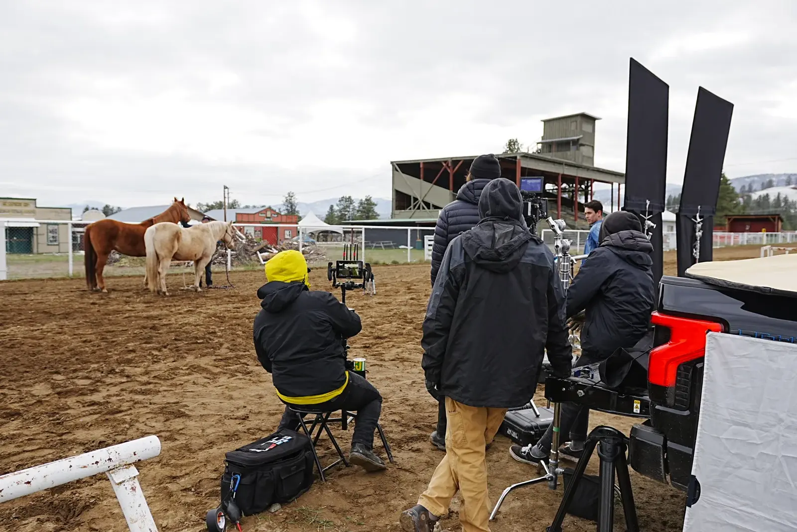 Camera and crew beside horses during a Princeton location setup