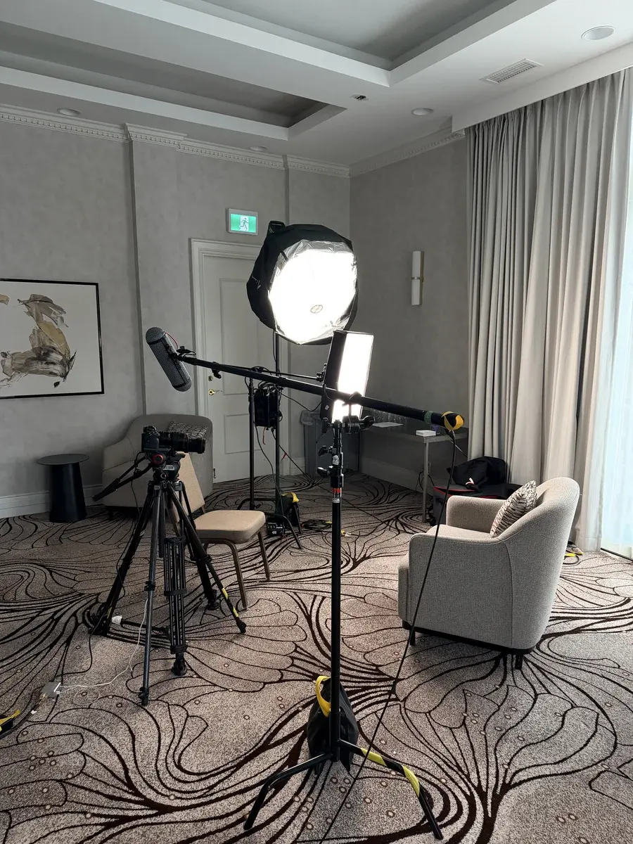 Interview chair, camera, soft light and boom mic prepared for SandBay Entertainment conference interviews