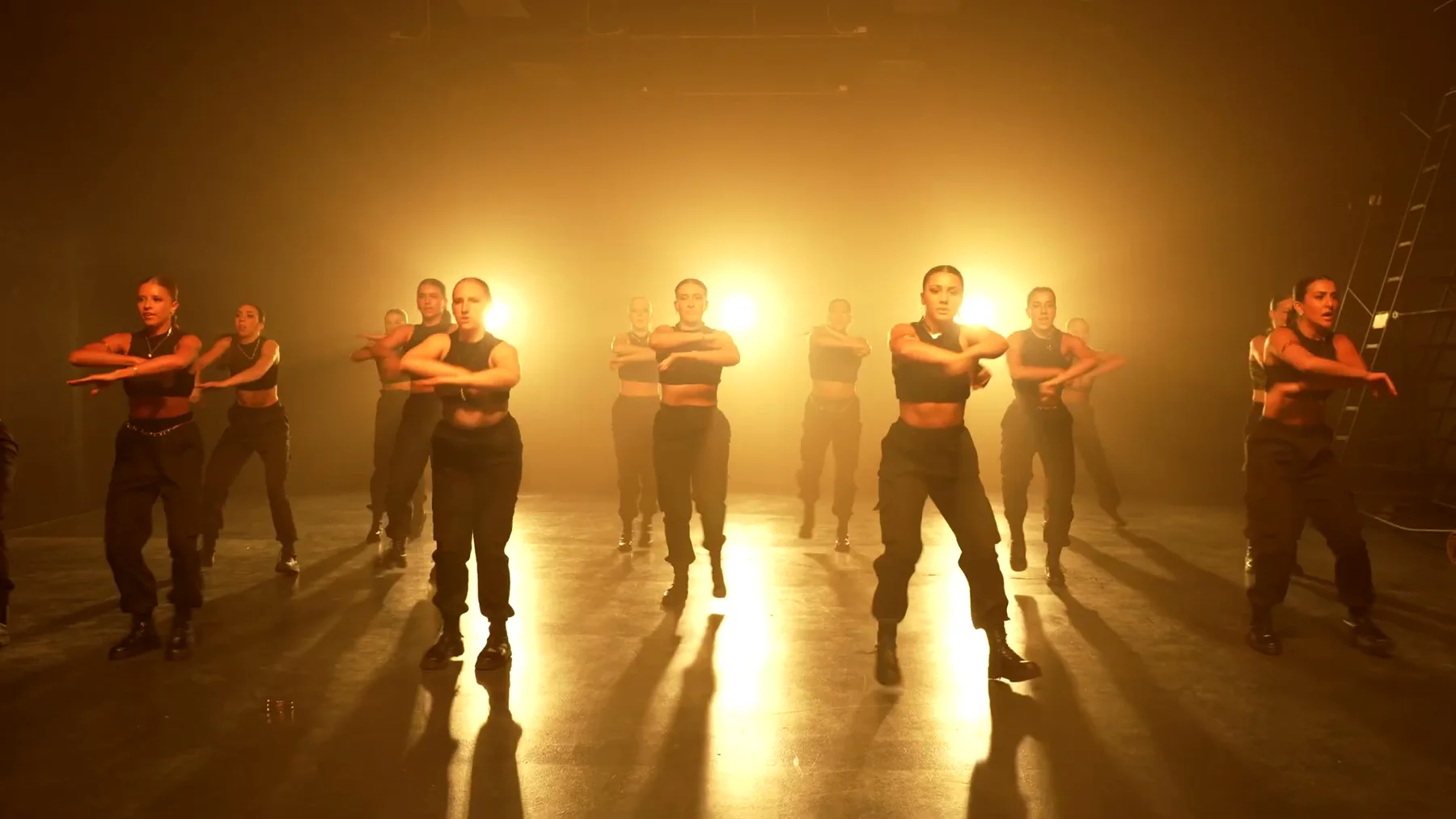 Sockeye ensemble moving forward through amber backlight in the 2023 film