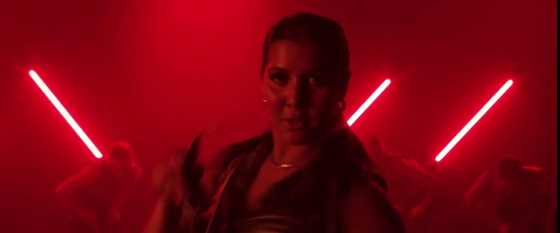 Sockeye dancer framed by red diagonal lights in the 2024 film