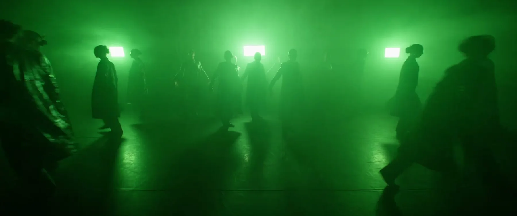Sockeye dancers silhouetted in green light and haze in the 2025 film
