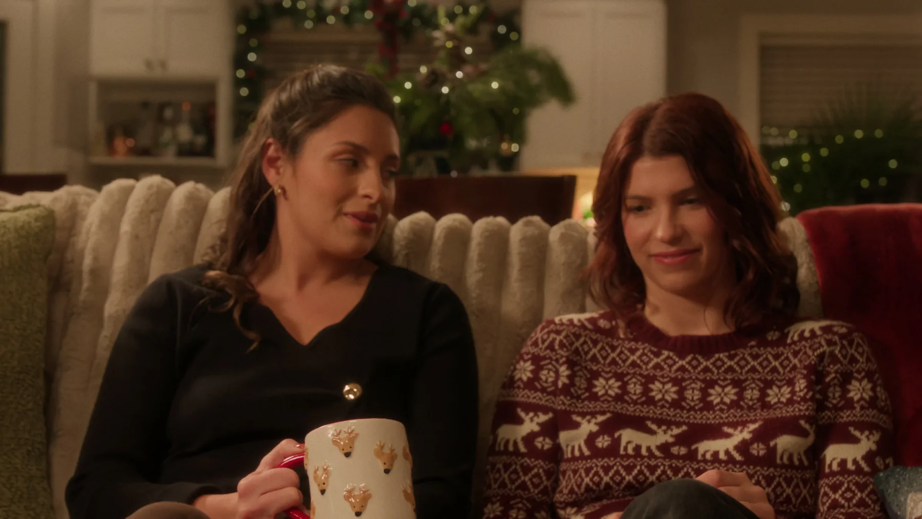 Finished-film frame of the two sisters seated together in the Christmas living room in The Letter